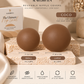 Slaved by Ten reusable nipple covers shown as two matte brown silicone covers labeled Small and Large, displayed on a stone block with product packaging and feature callouts on a warm beige background.