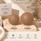 Slaved by Ten reusable nipple covers in caramel color, shown as two smooth silicone discs on a textured stone block with size labels Small (3 x 7.6 cm) and Large (4 x 10.