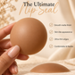 A hand holds a smooth matte nude-brown silicone nipple against a warm beige background with text reading 'The Ultimate Nip Seal' and feature checkmarks. A second dome-shaped silicone piece rests below on a textured surface.